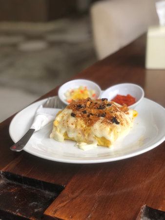 Kebuli Rice wrapped in omelette and toping with cheese mozarellaの写真素材