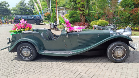 Batu City, East Java Province, Indonesia - November 2022 :  Dark Green Jaguar Classic Car Series SS100 2663cc 1937 with Flower Decorative Parked in Automotive Contestのeditorial素材