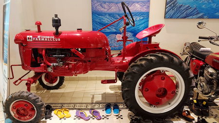 Yogyakarta, Indonesia - February 2023 : Red vintage tractor vehicle, old technology for plowing fieldsのeditorial素材