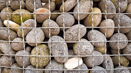 <p>natural stone in a wire box for or gabion</p>の写真素材