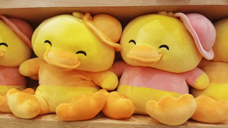 close up two funny yellow duck dolls in toys rack marketの写真素材