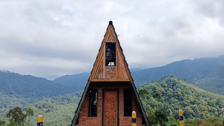 Triangular wooden house in the middle of a vegetable plantationの写真素材