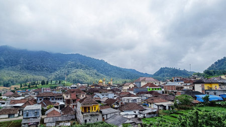 scenery of village houses with mountains and blue sky in the backgroundの写真素材