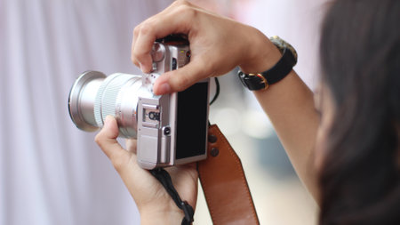 hand holding the camera to take a photo with portrait positionの写真素材