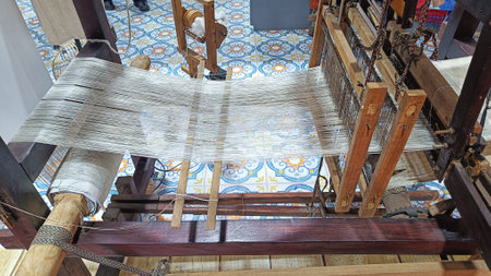 Weaving silk thread with a loom in traditional textile craftsの写真素材