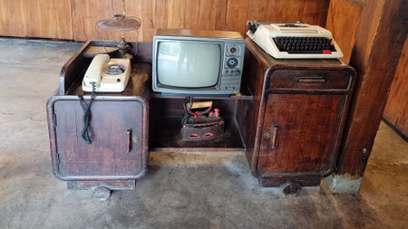 Classic analog television, radio, Manual antique Typewriter on wood table for decoration in the...