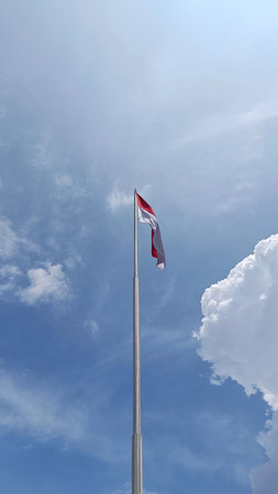 The National Flag of Indonesia, Red and White, flutters at the poleの写真素材