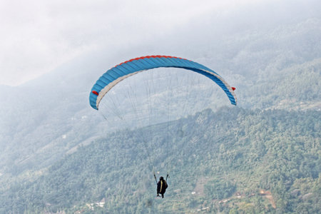 paraglider pilot fly in sky on beauty nature mountain landscape backgroundの写真素材