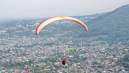 paraglider pilot fly in sky on beauty nature mountain landscape backgroundの写真素材
