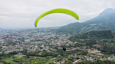 paraglider pilot fly in sky on beauty nature mountain landscape backgroundの写真素材