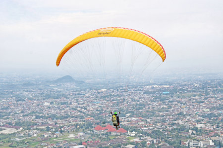 paraglider pilot fly in sky on nature mountain landscape backgroundの写真素材