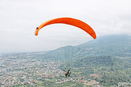paraglider pilot fly in sky on beauty nature mountain landscape backgroundの写真素材