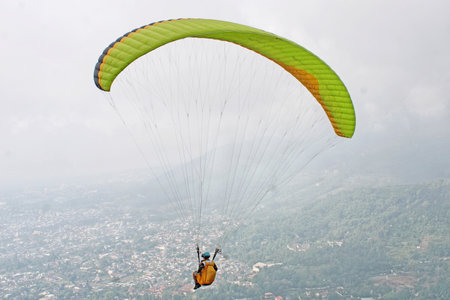 paraglider pilot fly in sky on beauty nature mountain landscape backgroundの写真素材