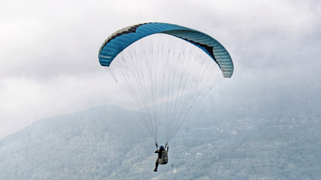 paraglider pilot fly in sky on beauty nature mountain landscape backgroundの写真素材