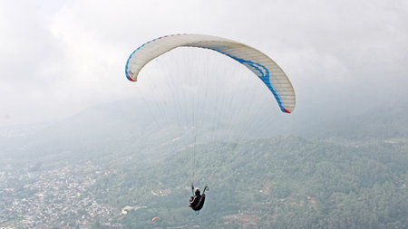 paraglider pilot fly in sky on beauty nature mountain landscape backgroundの写真素材