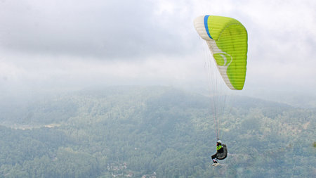 paraglider pilot fly in sky on beauty nature mountain landscape backgroundの写真素材