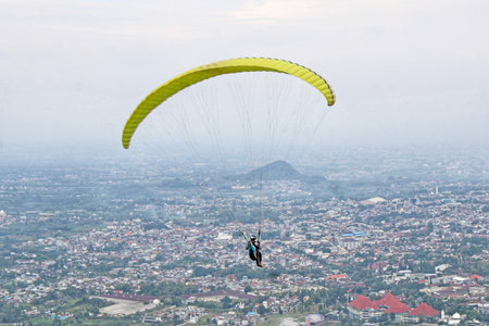 paraglider pilot fly in sky on beauty nature mountain landscape backgroundの写真素材