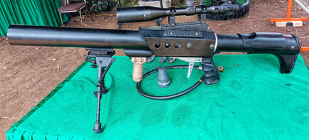 black military firearm gun displayed in green tableの写真素材