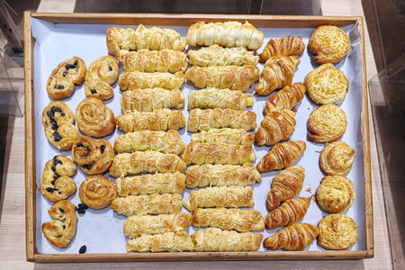 Delicious crunchy pastries and breads with various shapes and flavorsの写真素材