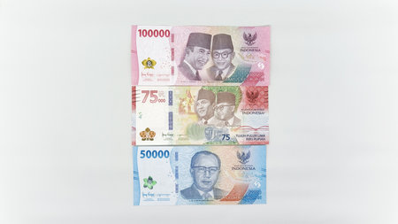 Indonesian banknotes in white envelope. Collection of banknotes in denominations 50000, 75000, 10000...