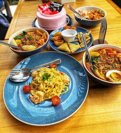 assorted delicious cafe food and snacks from Italy, Asian and Western served on the tableの写真素材