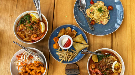 assorted delicious cafe food and snacks from Asian and Western served on the tableの写真素材
