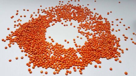 red lentils isolated on white backgroundの写真素材