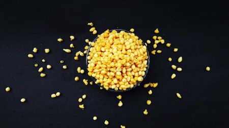 fresh and healthy deep fried gram flour balls in bowl isolated on black background