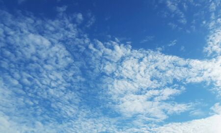 white fluffy clouds in blue skyの写真素材