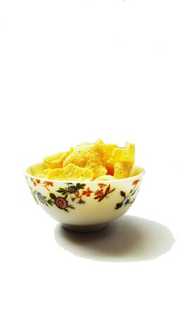 rice onion chips in bowl isolated on white backgroundの写真素材
