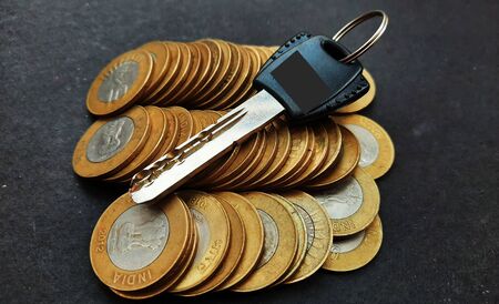 indian coins and key on it isolated on black backgroundの写真素材