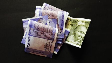 indian currency isolated on black background closeup image