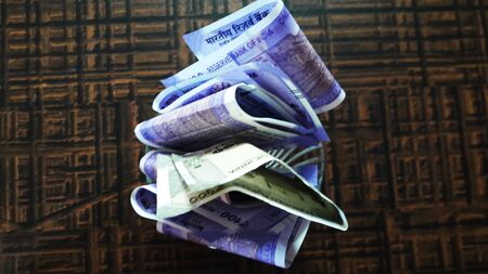 indian currency isolated on brown background closeup image