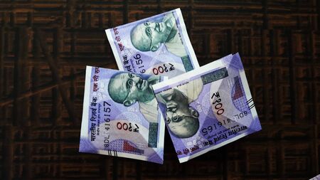 indian currency isolated on brown background closeup image