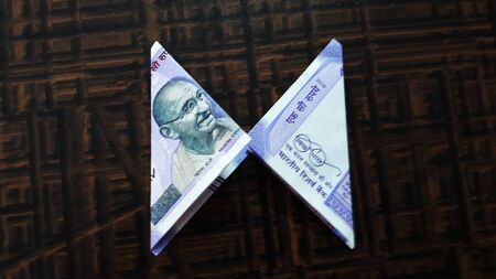 indian currency isolated on brown background closeup imageの写真素材