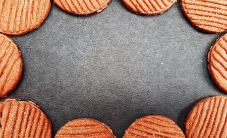 chocolate cookies frame isolated on black background with text space in middleの写真素材