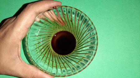 soya souse in bowl isolated on green background