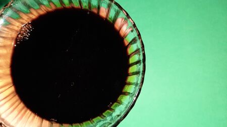 soya souse in bowl isolated on green background