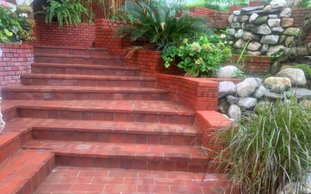staircase in the garden with brick wall and green plants.の写真素材