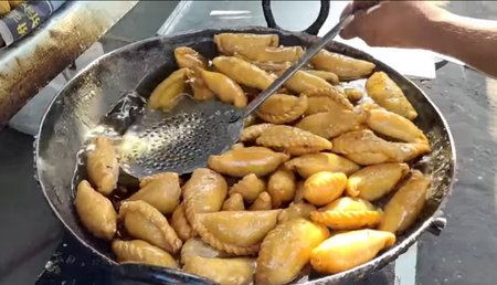 Fried dumplings in a frying pan on a street food marketの写真素材