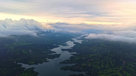 Aerial view of the lake and mountains in the clouds at sunsetの写真素材
