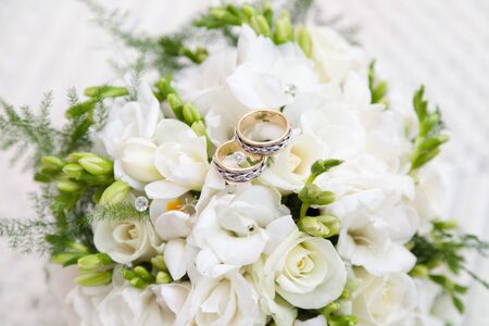 two wedding rings on bridal bouquetの写真素材