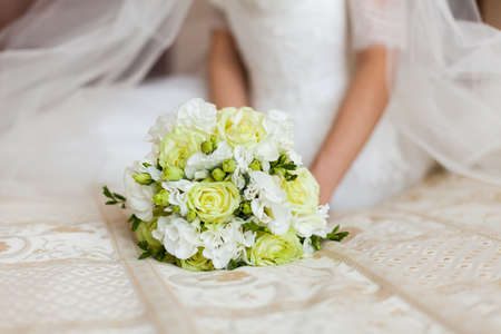 bride holding bouquet of flowers close upの写真素材