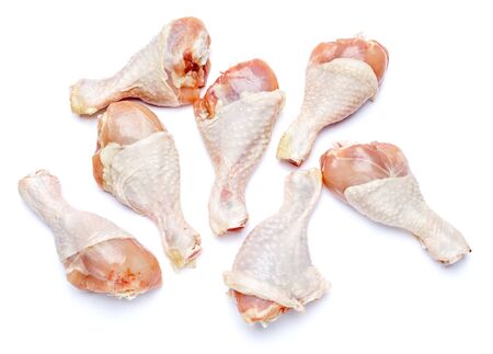 Raw chicken legs isolated on a white backgroundの写真素材
