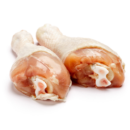 Raw chicken legs isolated on a white backgroundの写真素材