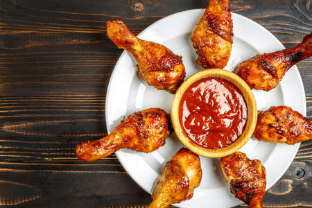 roasted chicken legs with herbs on wooden tableの写真素材