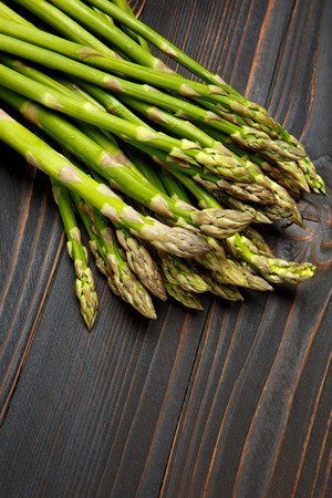 bundle of harvested fresh asparagus wooden backgroundの写真素材