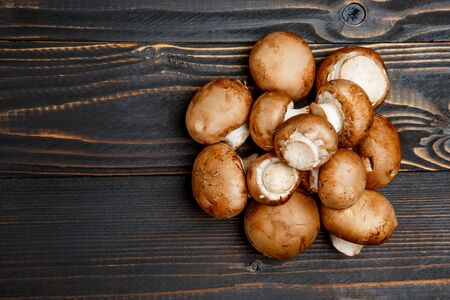 fresh champignon mushroom on wooden background or tableの写真素材