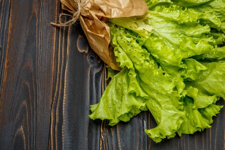 Fresh salad lettuce on wooden background or tableの写真素材
