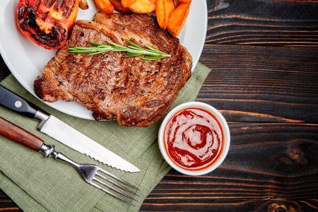 Roasted organic shin of beef meat on wooden table